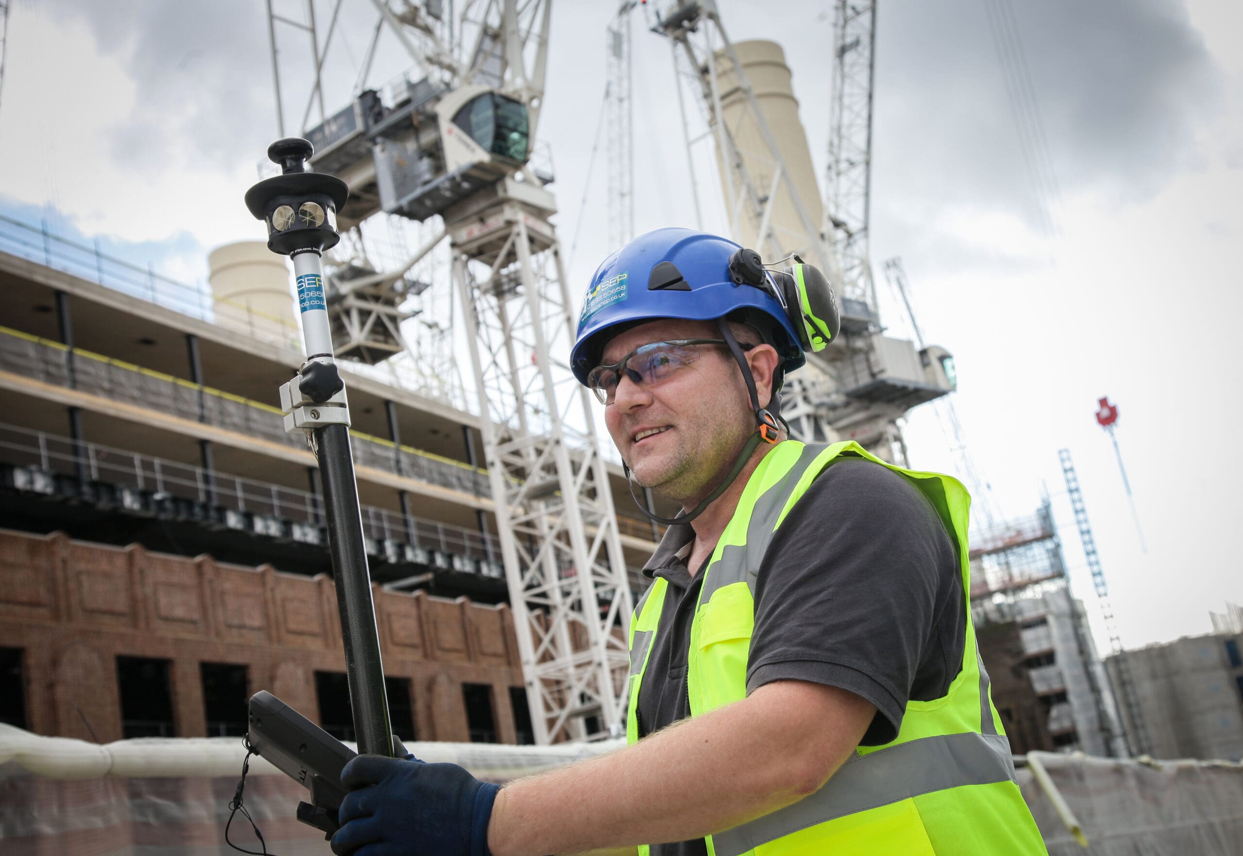Setting out engineer working on site layout in Haringey